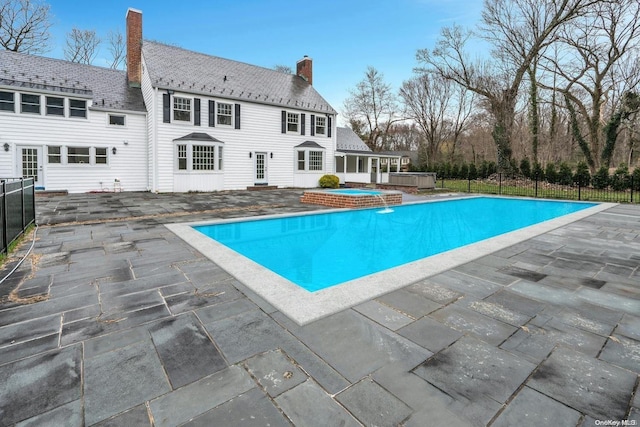 view of pool with an in ground hot tub and a patio