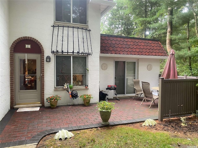 rear view of property featuring a patio area