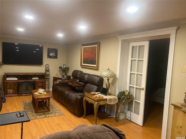 living room with hardwood / wood-style floors and ornamental molding