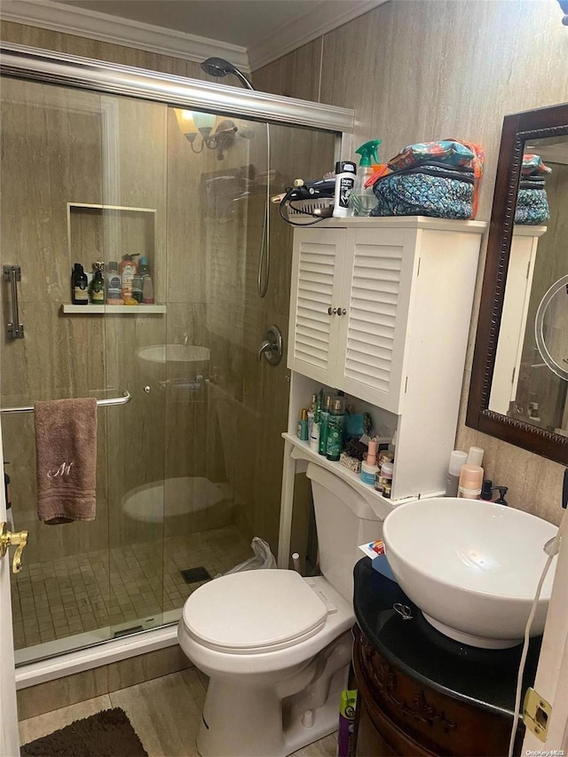 bathroom featuring walk in shower, toilet, vanity, and ornamental molding