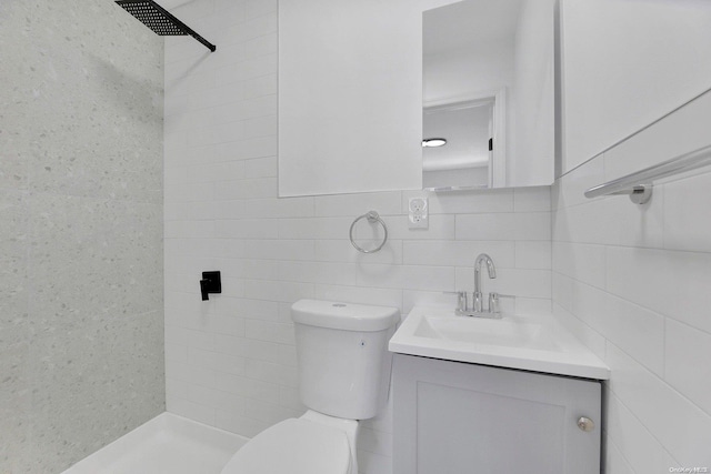 bathroom featuring vanity, toilet, and tile walls