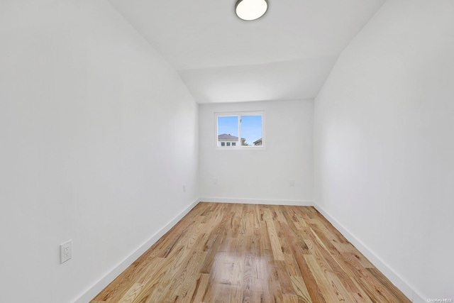 interior space with light hardwood / wood-style floors and lofted ceiling