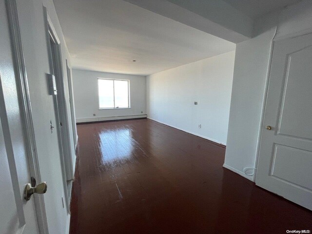 129 Bch 118th St Unit 6F, Rockaway Park, NY 11694 - unfurnished room with dark wood-type flooring, baseboards, and baseboard heating