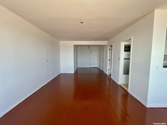 spare room with dark hardwood / wood-style floors