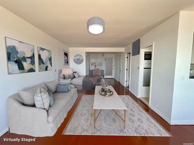 129 Bch 118th St Unit 6F, Rockaway Park, NY 11694 - living room with dark wood finished floors and baseboards