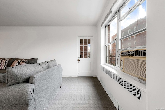 living room with a healthy amount of sunlight, radiator, and dark carpet