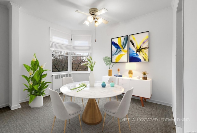 carpeted dining space featuring radiator heating unit, ceiling fan, and ornamental molding