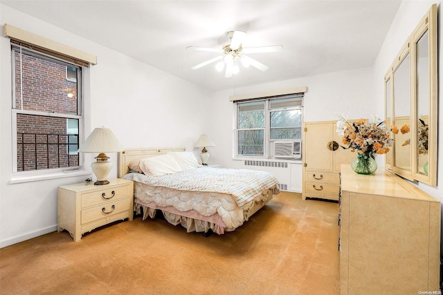 carpeted bedroom featuring radiator, ceiling fan, and cooling unit