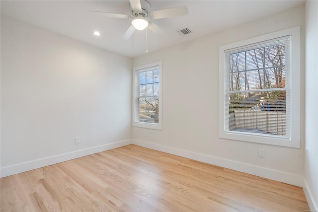 spare room with light wood-type flooring and ceiling fan