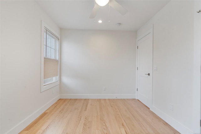 spare room featuring light wood-type flooring and ceiling fan