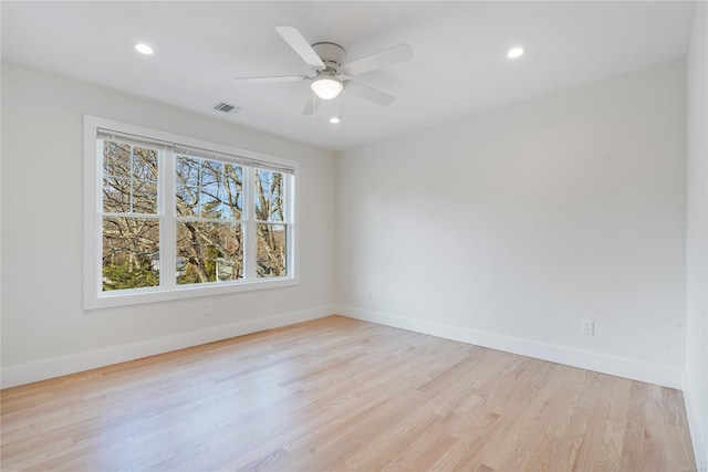 unfurnished room with ceiling fan and light hardwood / wood-style floors