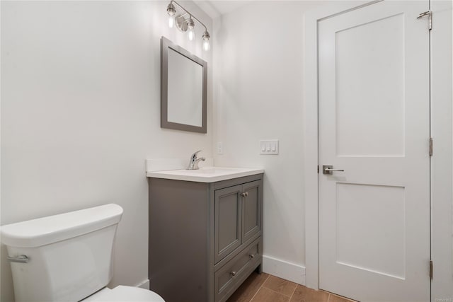 bathroom featuring toilet and vanity