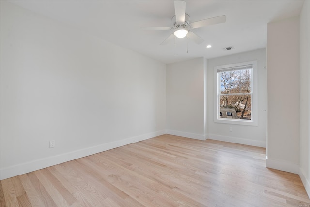 empty room featuring ceiling fan and light hardwood / wood-style floors