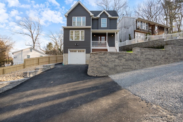 view of front of home featuring covered porch and a garage