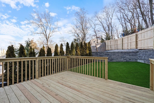 wooden deck featuring a lawn