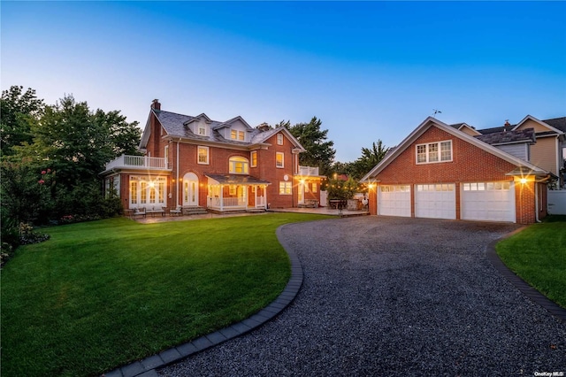 view of front of property with a yard and a balcony