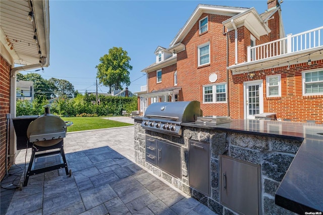 view of patio / terrace featuring a grill, a balcony, and area for grilling