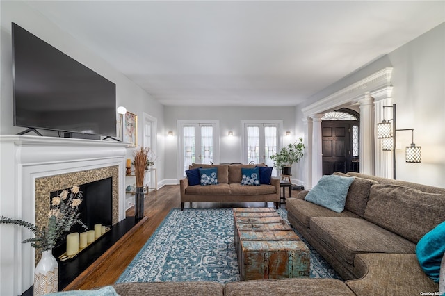 living room featuring ornate columns, french doors, a high end fireplace, and dark hardwood / wood-style floors