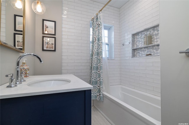 bathroom featuring shower / bath combo with shower curtain and vanity