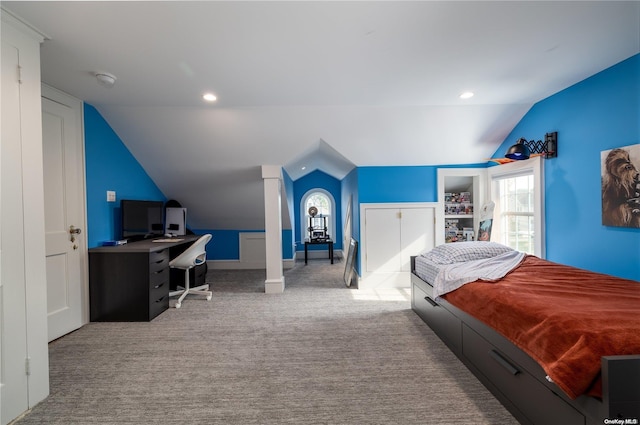 bedroom with light carpet and lofted ceiling