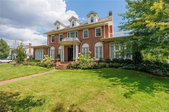 colonial inspired home with a front yard