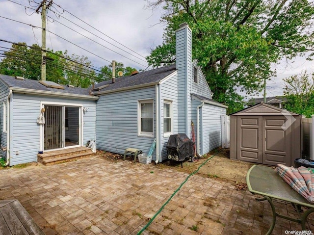 back of house featuring a shed and a patio