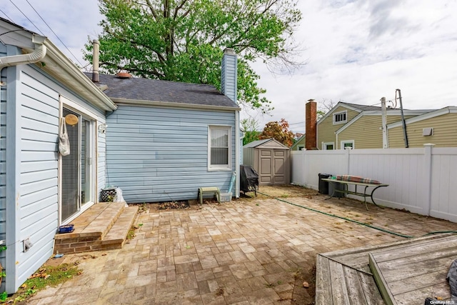 view of patio / terrace featuring a storage unit