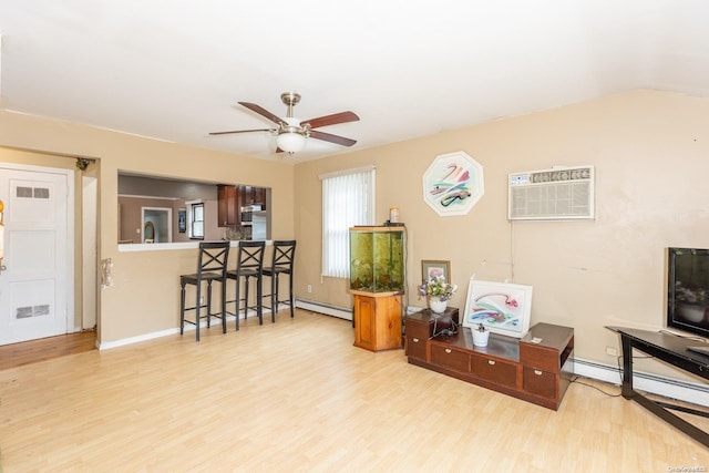 interior space featuring ceiling fan, a wall mounted AC, light hardwood / wood-style floors, and a baseboard heating unit