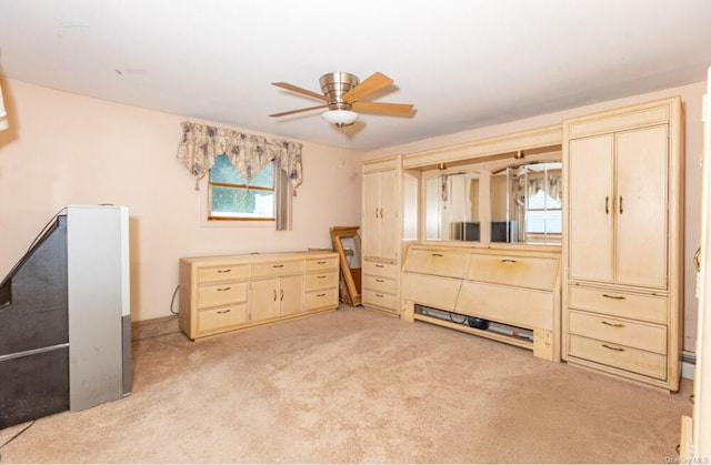 bedroom with ceiling fan and light carpet