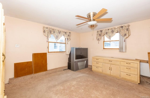 misc room with light colored carpet and ceiling fan