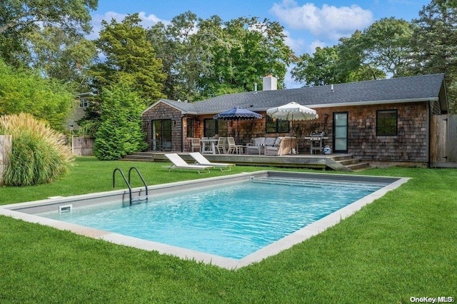 view of swimming pool with an outdoor hangout area, a yard, and a wooden deck