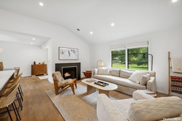 living room featuring dark hardwood / wood-style flooring and vaulted ceiling