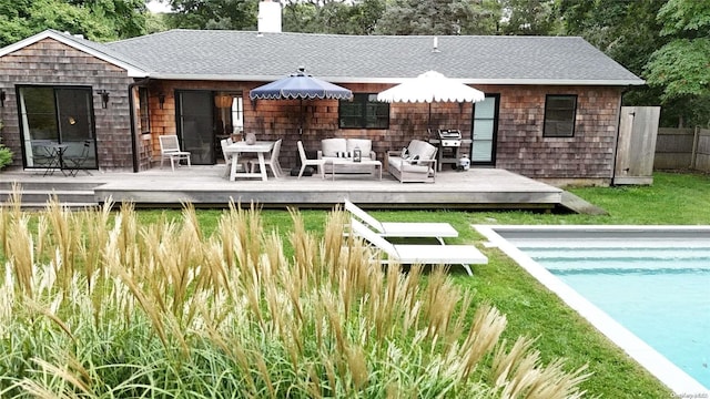 rear view of house with a swimming pool side deck and an outdoor hangout area