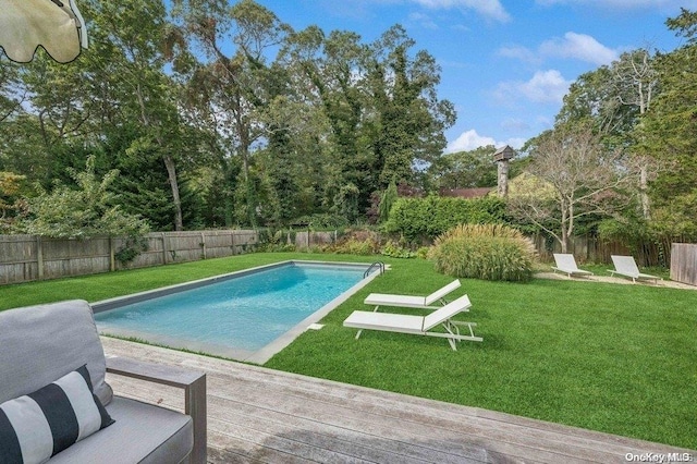 view of swimming pool featuring a lawn