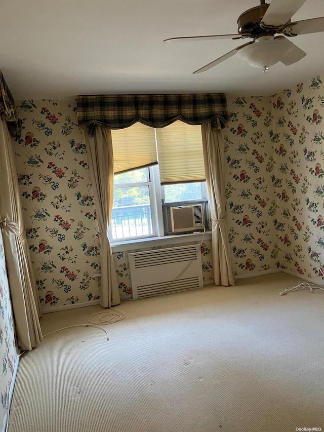 carpeted spare room with cooling unit, baseboards, wallpapered walls, a wall mounted AC, and ceiling fan