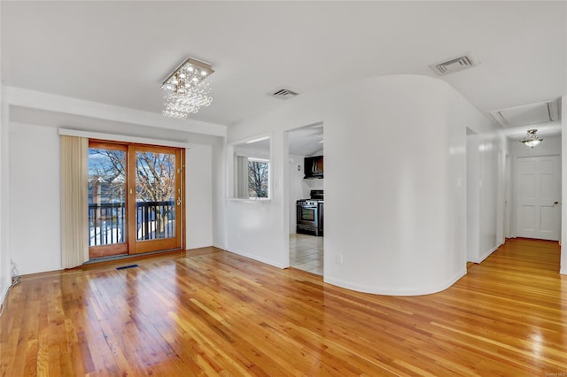 interior space featuring visible vents, light wood-style flooring, and attic access