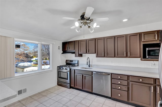 kitchen featuring visible vents, dark brown cabinetry, light countertops, stainless steel appliances, and a sink