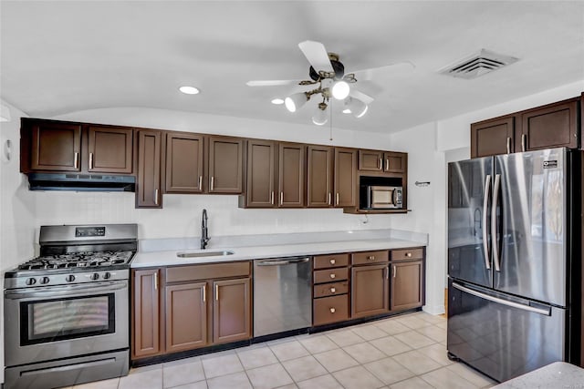 kitchen with visible vents, a sink, under cabinet range hood, stainless steel appliances, and light countertops