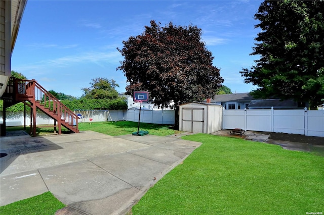 view of yard with a shed, stairs, an outdoor structure, a fenced backyard, and a patio area