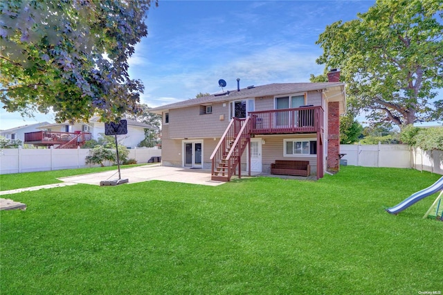 back of house with a lawn, a fenced backyard, a chimney, and a patio area