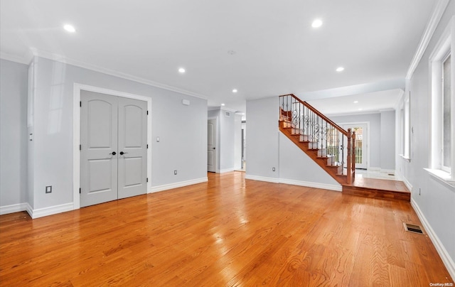 unfurnished living room featuring light hardwood / wood-style floors and ornamental molding