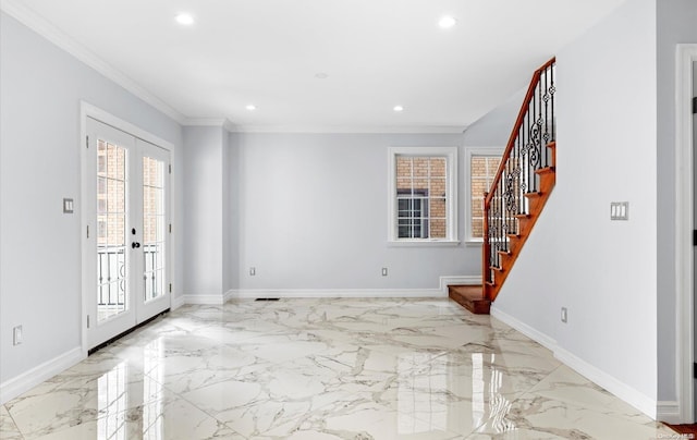 foyer featuring french doors, plenty of natural light, and ornamental molding