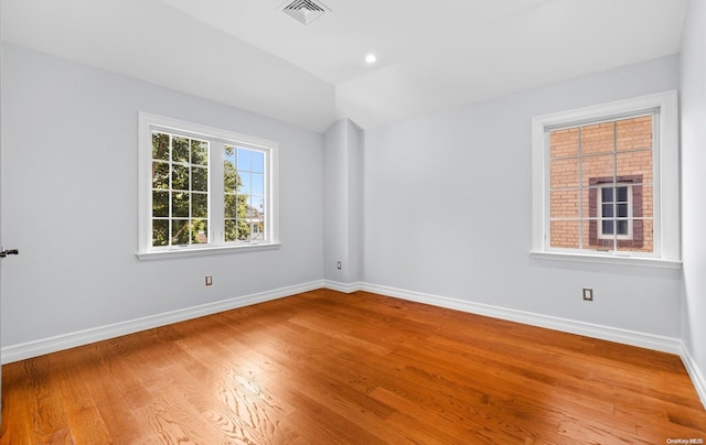 empty room with hardwood / wood-style flooring