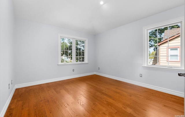 empty room with hardwood / wood-style flooring