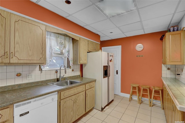 kitchen with decorative backsplash, a drop ceiling, white appliances, and sink