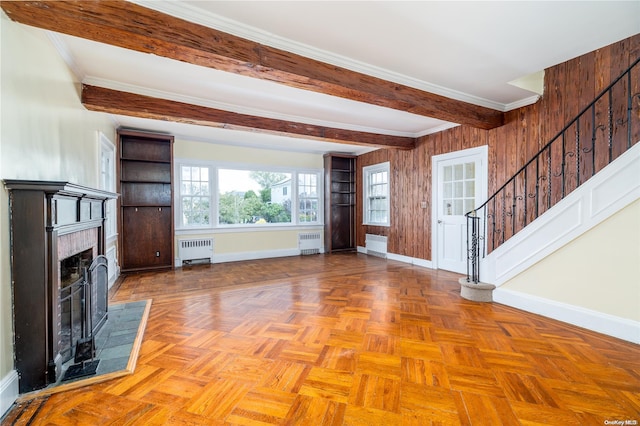 unfurnished living room featuring light parquet flooring, radiator, and crown molding