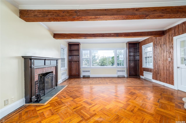 unfurnished living room with radiator heating unit and a wealth of natural light