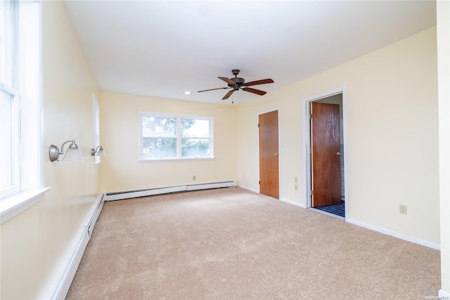 unfurnished room featuring light carpet, ceiling fan, and a baseboard radiator