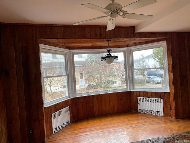 unfurnished dining area with radiator and wooden walls