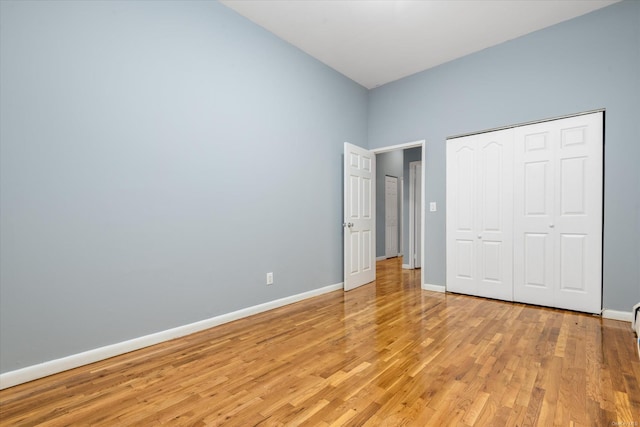 unfurnished bedroom with light hardwood / wood-style floors and a closet